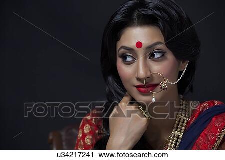 Stock Image - A beautiful bride with jewelery. Fotosearch