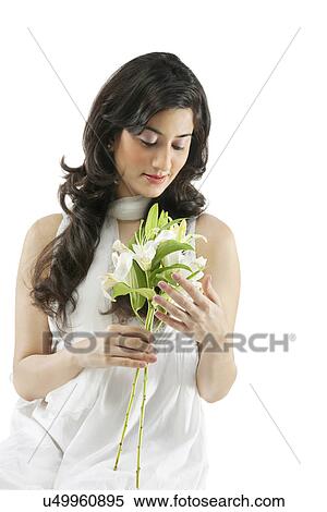 A beautiful woman holding flowers View Large Photo Image Stock Photography - A beautiful woman holding flowers . Fotosearch