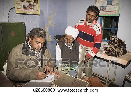 Stock Image - A doctor prescribes medication for his patients . Fotosearch