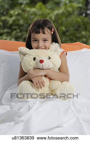 A girl with her teddy bear View Large Photo Image Stock Photo - A girl with her teddy bear . Fotosearch
