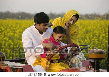 A typical rural family on a tractor View Large Photo Image Stock Photograph - A typical rural family on a tractor . Fotosearch