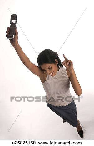 Stock Image - A woman holding a mobile phone . Fotosearch