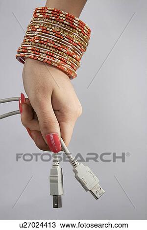 A woman holding plug-ins View Large Photo Image Stock Image - A woman holding plug-ins . Fotosearch
