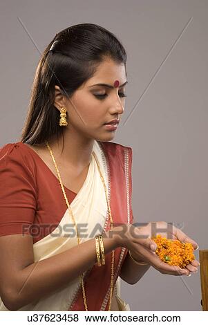 Stock Photo - A woman offering flowers . Fotosearch