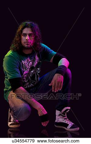 Stock Photo - A young man squatting . Fotosearch