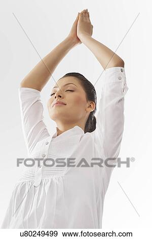 Stock Photo - An attractive woman in mountain pose . Fotosearch
