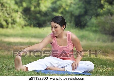 Stock Image - An attractive woman stretching . Fotosearch