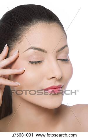 Stock Image - An attractive woman with eyes closed . Fotosearch