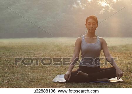 Stock Photograph - An attractive young woman doing yoga . Fotosearch