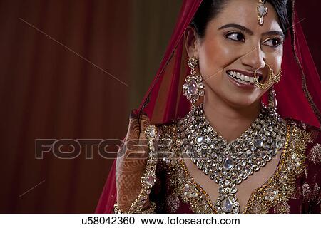 An attractive young woman in wedding dress looking away View Large Photo Image Stock Image - An attractive young woman in wedding dress looking away . Fotosearch