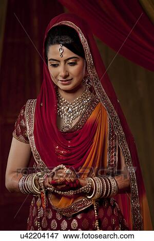 Stock Photo - An Indian bride looking down . Fotosearch