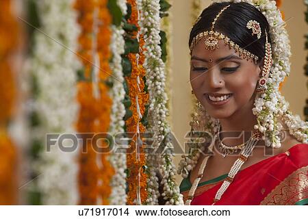An Indian woman in traditional clothing smiling View Large Photo Image Picture - An Indian woman in traditional clothing smiling . Fotosearch