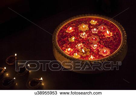 Stock Image - An urn with floating diyas. Fotosearch