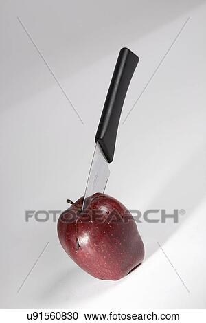 Stock Image - Apple with a knife . Fotosearch