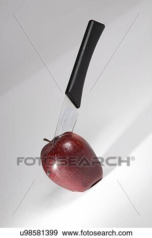 Stock Photo - Apple with a knife . Fotosearch