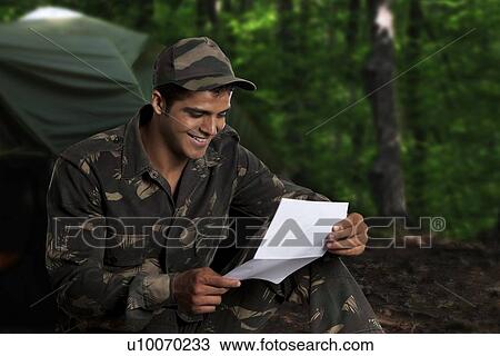 Stock Image - Army soldier reading a letter . Fotosearch