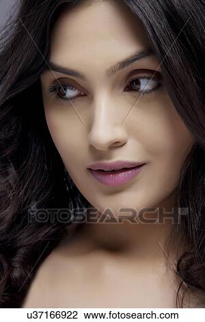 Attractive young female looking sideways View Large Photo Image Stock Image - Attractive young female looking sideways . Fotosearch