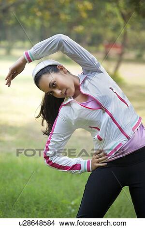 Picture - Attractive young woman exercising . Fotosearch