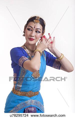 Picture - Beautiful Bharat Natyam dancer performing over white background. Fotosearch