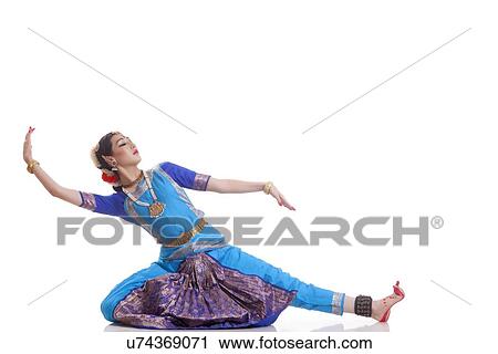 Stock Image - Beautiful Bharat Natyam dancer performing over white background. Fotosearch