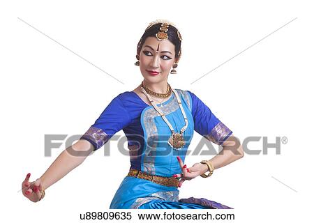 Stock Photography - Beautiful Bharat Natyam dancer performing over white background. Fotosearch