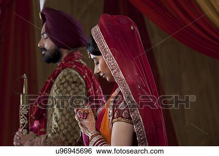 Beautiful bride standing with her husband on a wedding day View Large Photo Image Stock Photograph - Beautiful bride standing with her husband on a wedding day . Fotosearch