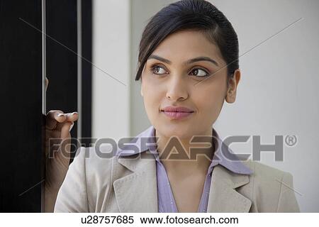 Beautiful businesswoman contemplating at workplace View Large Photo Image Stock Photography - Beautiful businesswoman contemplating at workplace . Fotosearch