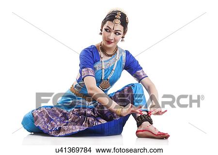 Picture - Beautiful dancer performing Bharatanatyam against white background. Fotosearch