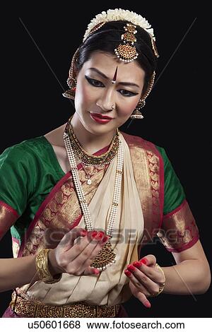 Beautiful dancer performing Bharatanatyam over black background View Large Photo Image Stock Photo - Beautiful dancer performing Bharatanatyam over black background. Fotosearch