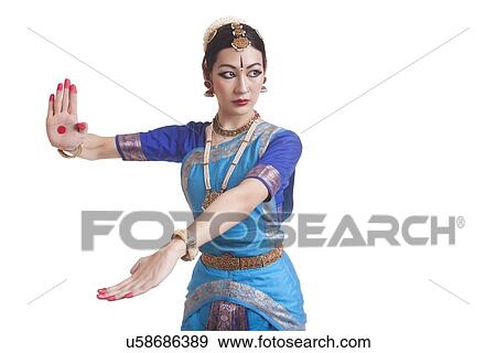 Beautiful dancer performing Bharatanatyam against white background View Large Photo Image Stock Photo - Beautiful dancer performing Bharatanatyam against white background. Fotosearch