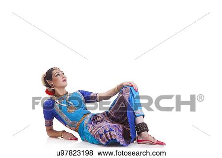Stock Photo - Beautiful dancer performing Bharatanatyam over white background. Fotosearch