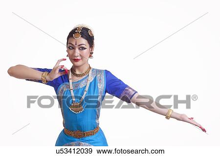 Stock Photo - Beautiful female performing classical dance on white background. Fotosearch