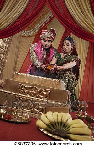 Stock Photograph - Beautiful Indian couple during their wedding ceremony . Fotosearch