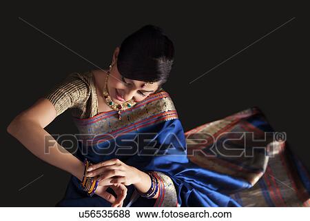 Beautiful woman admiring her bangles View Large Photo Image Stock Photo - Beautiful woman admiring her bangles . Fotosearch