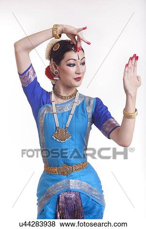 Stock Photo - Beautiful woman in Bharatanatyam pose over white background. Fotosearch