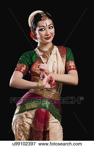 Beautiful woman performing Bharatanatyam on black background View Large Photo Image Stock Photo - Beautiful woman performing Bharatanatyam on black background. Fotosearch