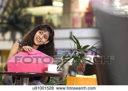 Beautiful woman smiling with bag and coffee cup View Large Photo Image Stock Photo - Beautiful woman smiling with bag and coffee cup . Fotosearch