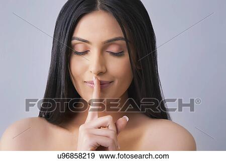Beautiful woman with eyes closed gestures for silence over colored background View Large Photo Image Stock Photo - Beautiful woman with eyes closed gestures for silence over colored background . Fotosearch