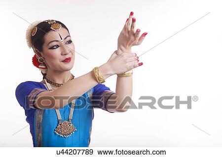 Stock Photo - Beautiful young dancer performing Bharatanatyam over white background. Fotosearch