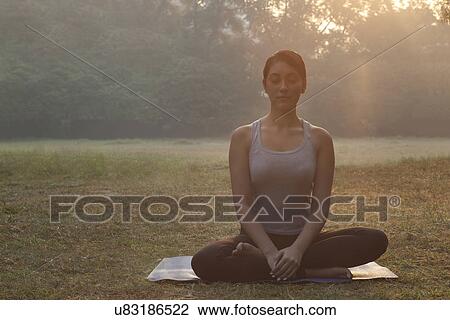 Stock Image - Beautiful young woman doing yoga . Fotosearch