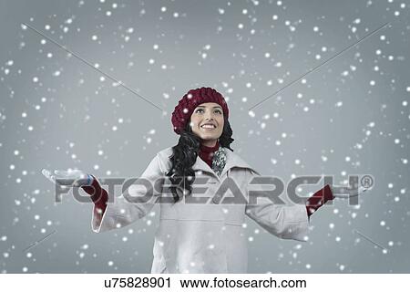 Stock Image - Beautiful young woman enjoying winter . Fotosearch