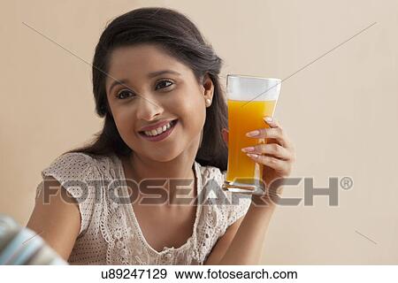 Beautiful young woman having orange juice with man View Large Photo Image Stock Photo - Beautiful young woman having orange juice with man . Fotosearch