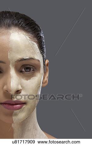Beautiful young woman with cosmetic mask on her face View Large Photo Image Stock Photo - Beautiful young woman with cosmetic mask on her face . Fotosearch