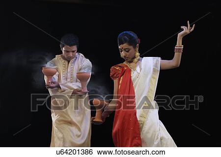 Stock Photograph - Bengali couple doing a Dhunuchi dance . Fotosearch