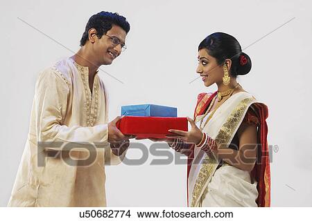 Bengali couple holding gifts View Large Photo Image Picture - Bengali couple holding gifts . Fotosearch