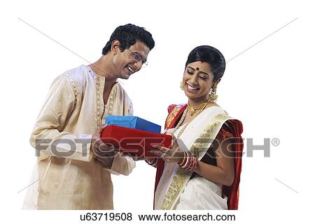 Stock Photo - Bengali couple holding gifts . Fotosearch