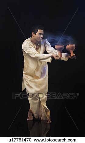 Bengali man doing a Dhunuchi dance View Large Photo Image Stock Image - Bengali man doing a Dhunuchi dance . Fotosearch