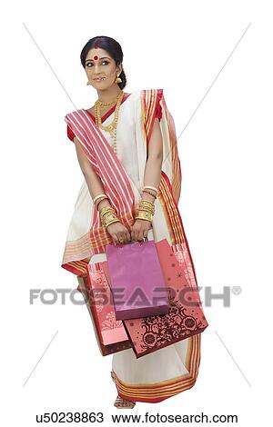 Stock Image - Bengali woman carrying shopping bags. Fotosearch