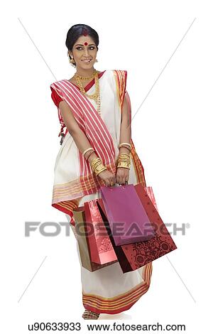 Stock Image - Bengali woman carrying shopping bags. Fotosearch
