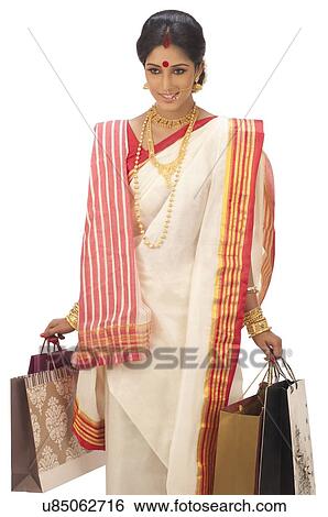 Bengali woman carrying shopping bags View Large Photo Image Stock Photograph - Bengali woman carrying shopping bags. Fotosearch